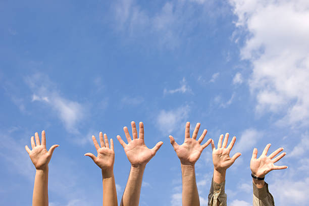 istock Hands rised up in air across  sky 119768733