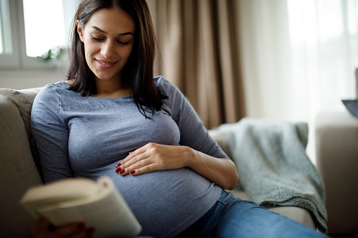 Pregnant woman reading a book