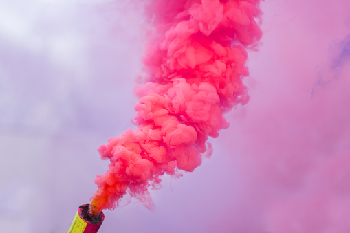 pink smoke bomb .festival color smoke signal burning