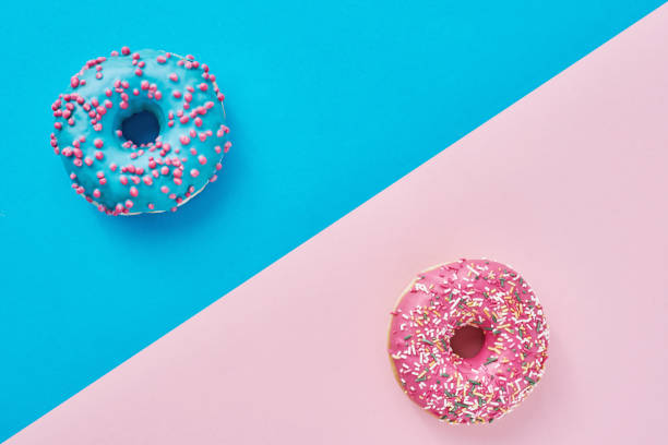 istock Two donuts on a pastel pink and blue background. Minimalism creative food composition. Flat lay style 1197700431