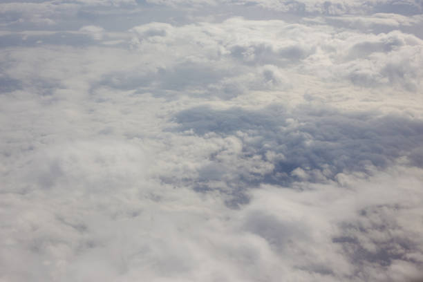 istock Aerial sky and fluffy clouds background. View from airplane porthole 1197700471