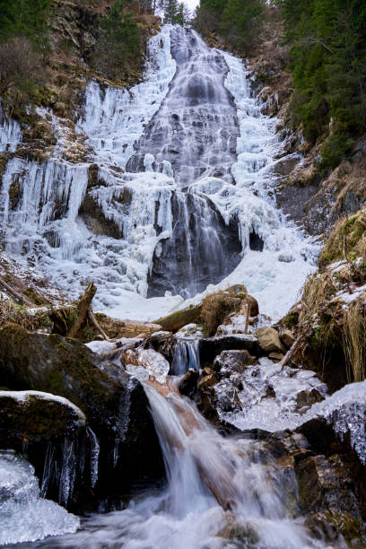 istock Mountain waterfall partly frozen 1197700816