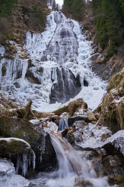 istock Mountain waterfall partly frozen 1197700823