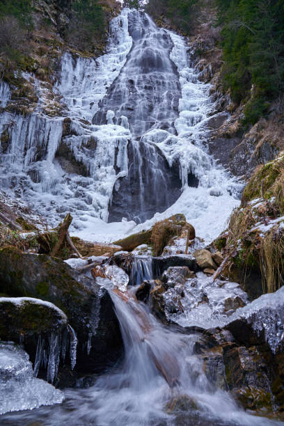 istock Mountain waterfall partly frozen 1197700830