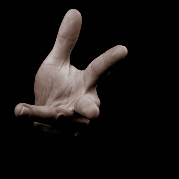 istock Human hand on black background counting on fingers 1197701652