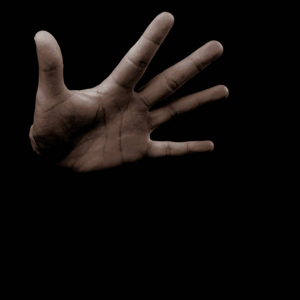istock Open male hand on dark background 1197701673