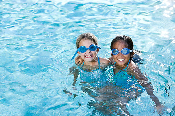 Best friends, girls smiling in swimming pool  children only stock pictures, royalty-free photos & images