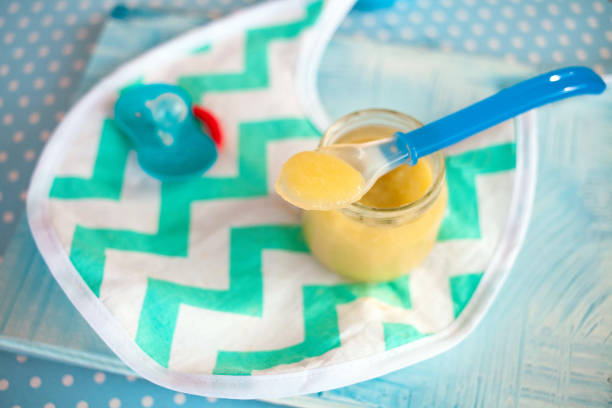 istock baby mashed with spoon in glass jar 1197706620