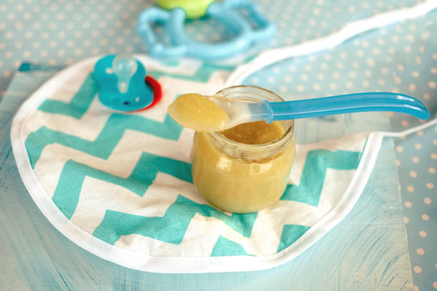 istock baby mashed with spoon in glass jar 1197706659