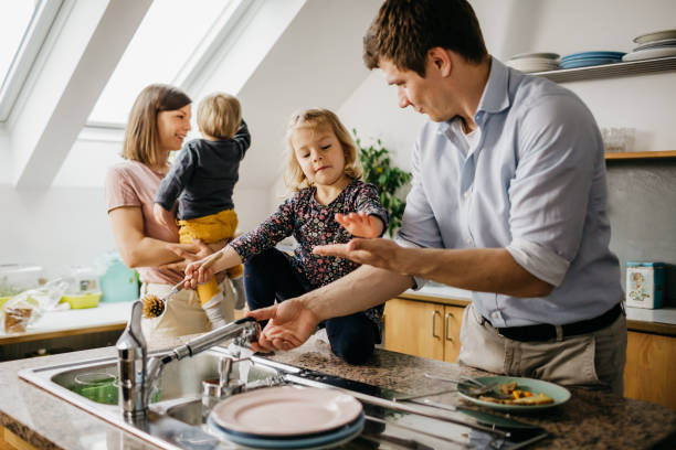 istock Family doing the dishes together 1197706789