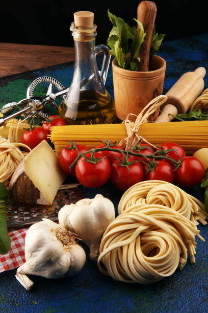 istock Pasta, vegetables, herbs and spices for Italian food on rustic table 1197707092