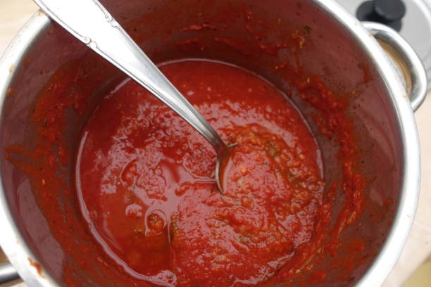 istock Tomato sauce being cooked in a pan 1197707679