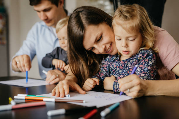 istock Young family drawing with color markers 1197708973