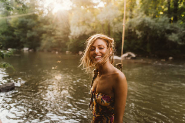istock Young woman bathing in the river 1197709785