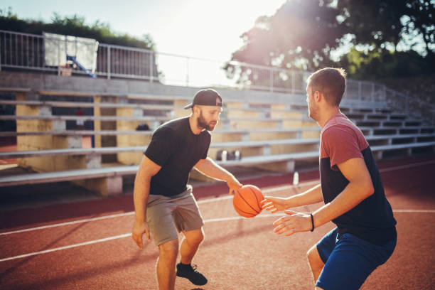 istock Basketball players on court 1197713210