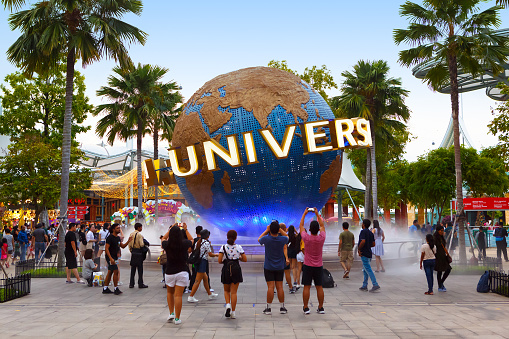 SINGAPORE-November 28, 2019: Tourists and theme park visitors taking pictures of the large globe in front of Universal Studios. Sentosa island