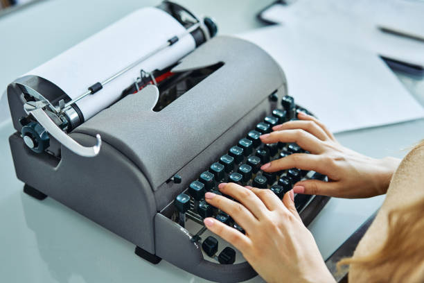 close up of woman typing with old typewriter - author writing retro revival women imagens e fotografias de stock