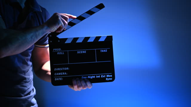 Film Production Worker with Clapperboard in Hands.