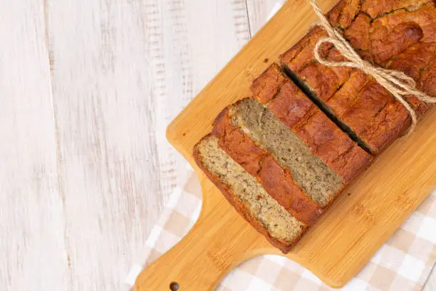 Banana bread made gluten free with almond flour on wooden cutting board