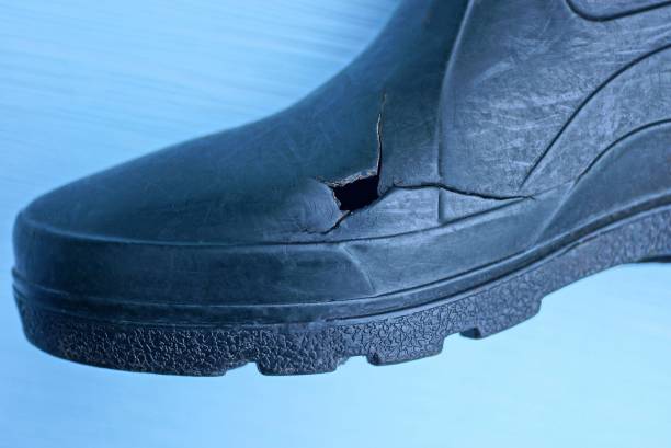 Many pairs of children's boots are placed in the room at home or kindergarten