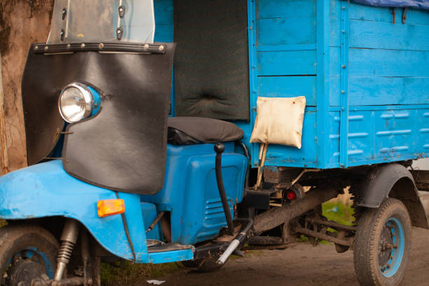 istock Unusual old tricycle rides on the road. 1197728346