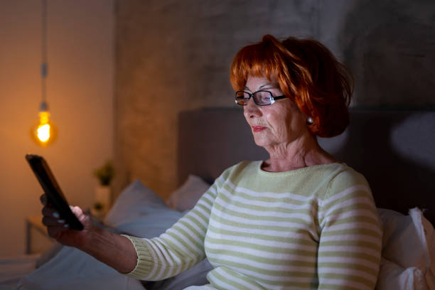 istock Senior woman having a video call using smart phone 1197728921