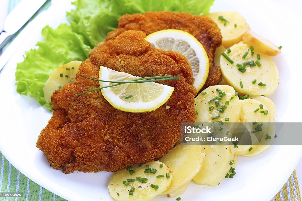 Overhead view of a Wiener Schnitzel with potato and salad Wiener Schnitzel with potato salad Potato Salad Stock Photo