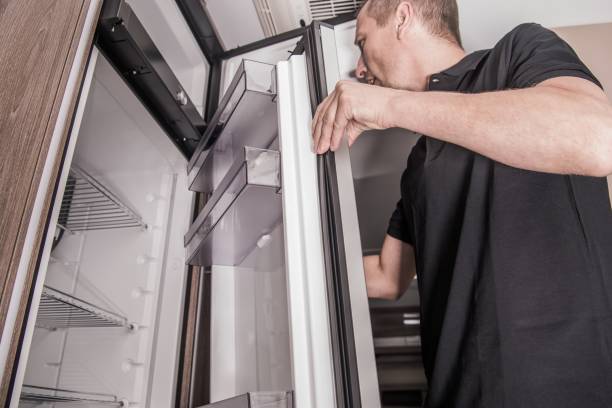 RV Camper Refrigerator Replacing Refrigerator Replacing Inside Camper RV Motorhome by Caucasian Appliances Technician. fridge FIX stock pictures, royalty-free photos & images