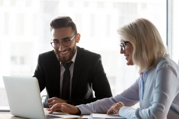 istock Smiling diverse businesspeople brainstorm cooperating on laptop 1197735156