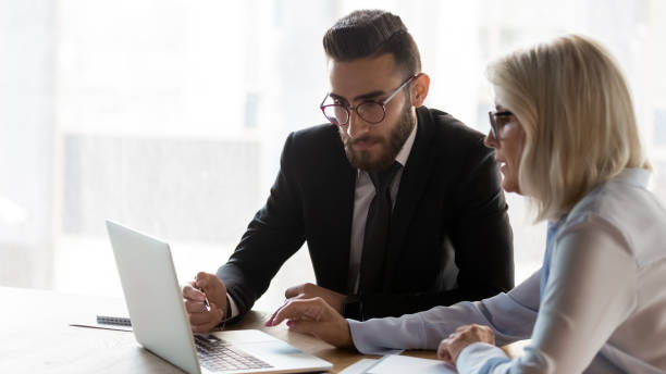 istock Diverse colleagues work on laptop discussing ideas at meeting 1197735158