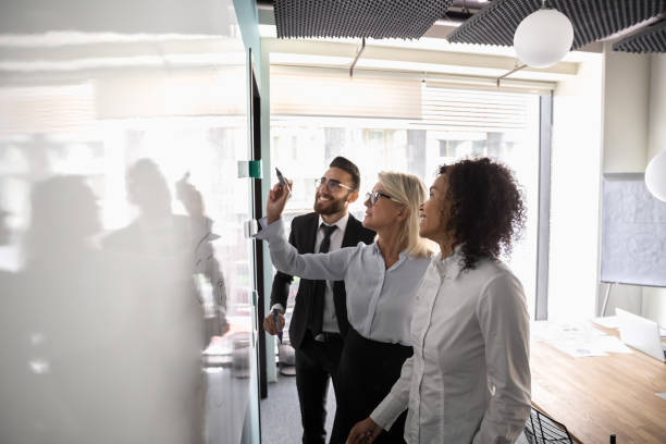 istock Motivated diverse employees brainstorm develop strategies on whiteboard 1197735189