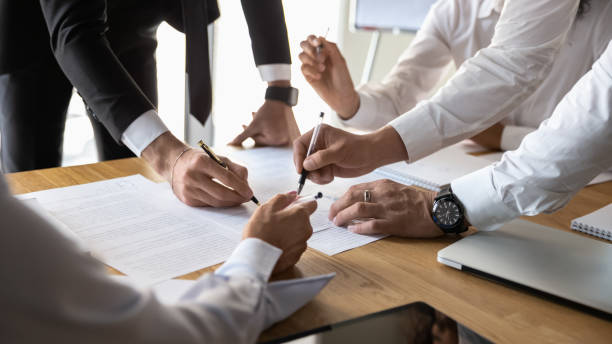 istock Diverse businesspeople discuss financial paperwork at office briefing 1197735193