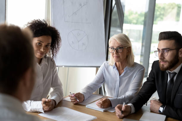 istock Diverse employees cooperate at briefing discussing ideas 1197735202