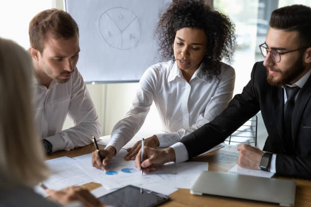 istock Multiracial colleagues discuss paperwork document at office briefing 1197735205
