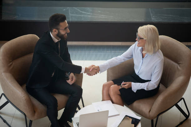 istock Smiling diverse businesspeople shake hands get acquainted at meeting 1197735220