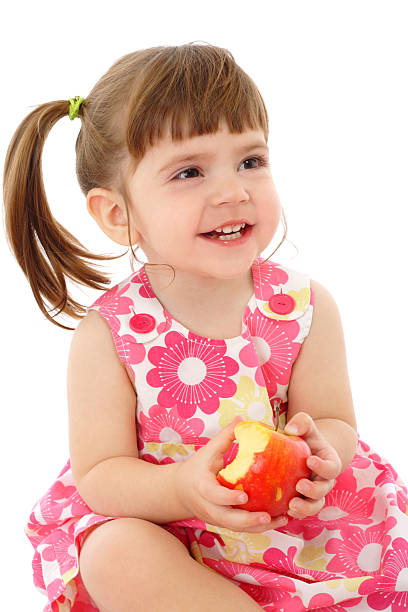 istock Smiling little girl with apple 119773572