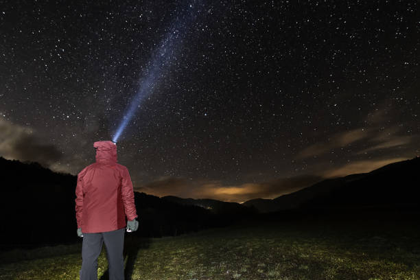 istock man with headlamp looking at the starry night sky 1197735844