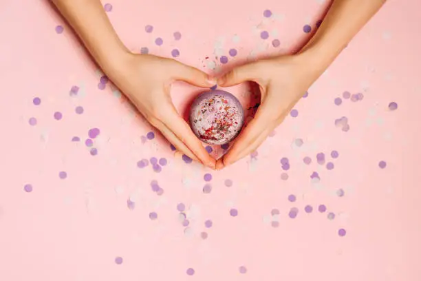 Photo of Flat lay photo with bath bomb in hands of girl.