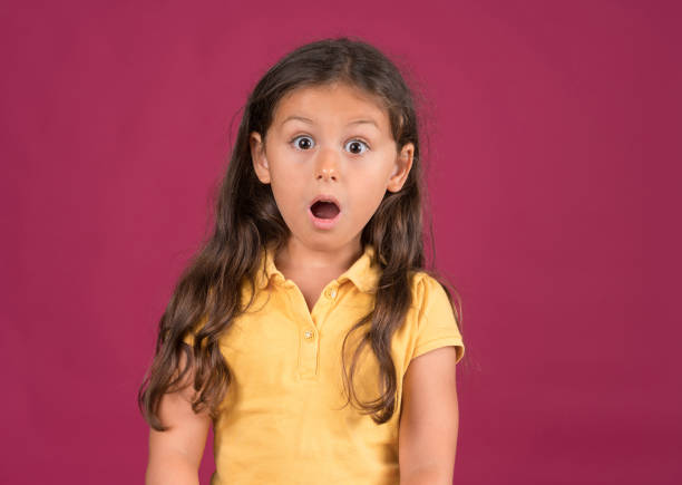 Cute little girl shouting with a surprised face expression