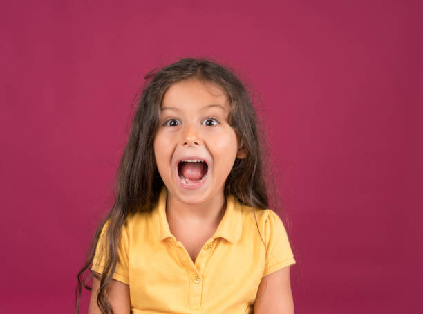 istock Cute little girl shouting with a surprised face expression 1197736473