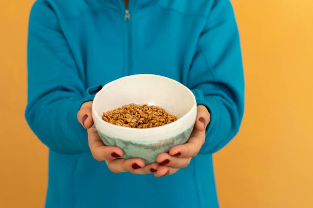 Young woman with muesli bowl