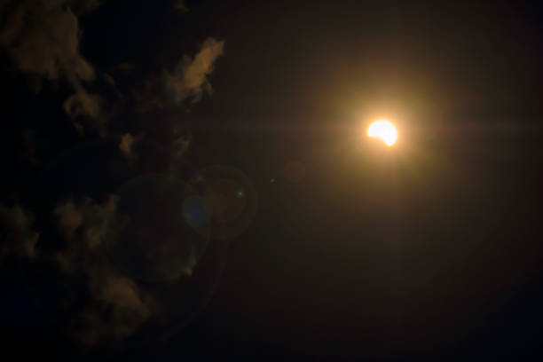 istock Half the shadow of the solar eclipse with white cloud on dark sky background Is a natural phenomenon on Earth that is rare to see 1197745129