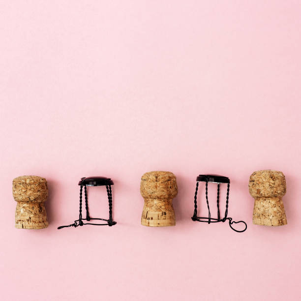 istock Creative layout with corks and muselets from champagne and heart on pink paper with copy space. Background for Birthday, party, wedding. Hen-party greeting card. 1197745176