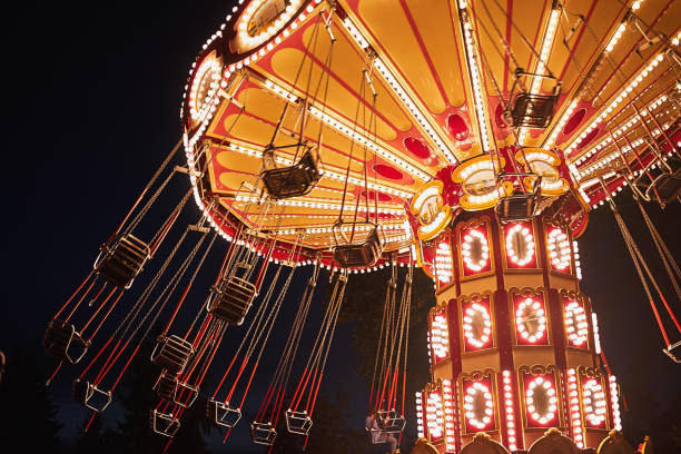 istock Illuminated swing chain carousel in amusement park at the night 1197745178