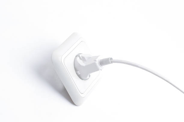 istock plug into an electrical outlet.isolated on a white background. closeup. 1197750176