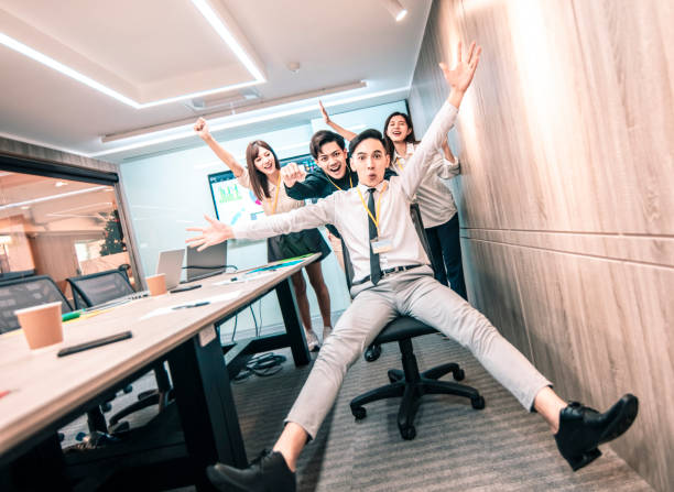 istock business people having fun riding on chairs in office 1197750898
