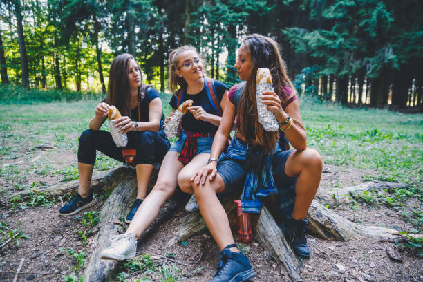 istock Smiling women eating sandwich in forest 1197752106