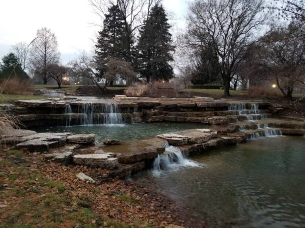 istock Cascading waterfalls in man made stream in public park 1197757282