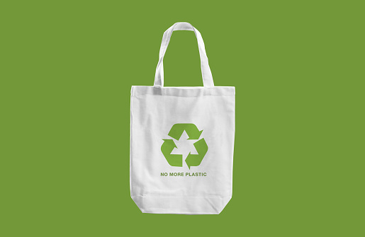 white cloth bag with Recycle sign logo and words \