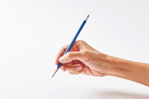 A man trying to write letters with pencil on paper